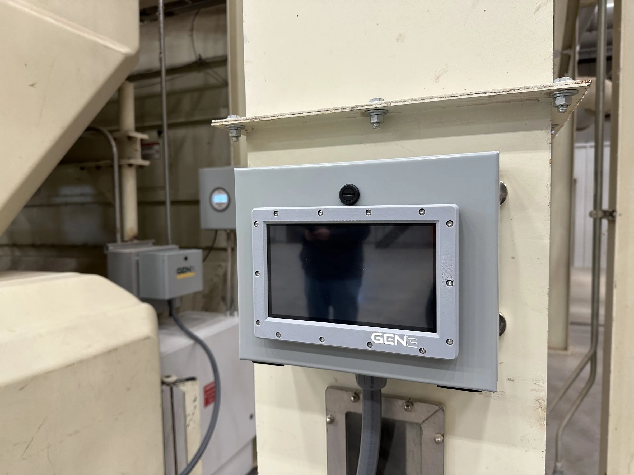 A sealed Gen 3 Dynamics panel-mount touchscreen bolted to a structural column in a gin
