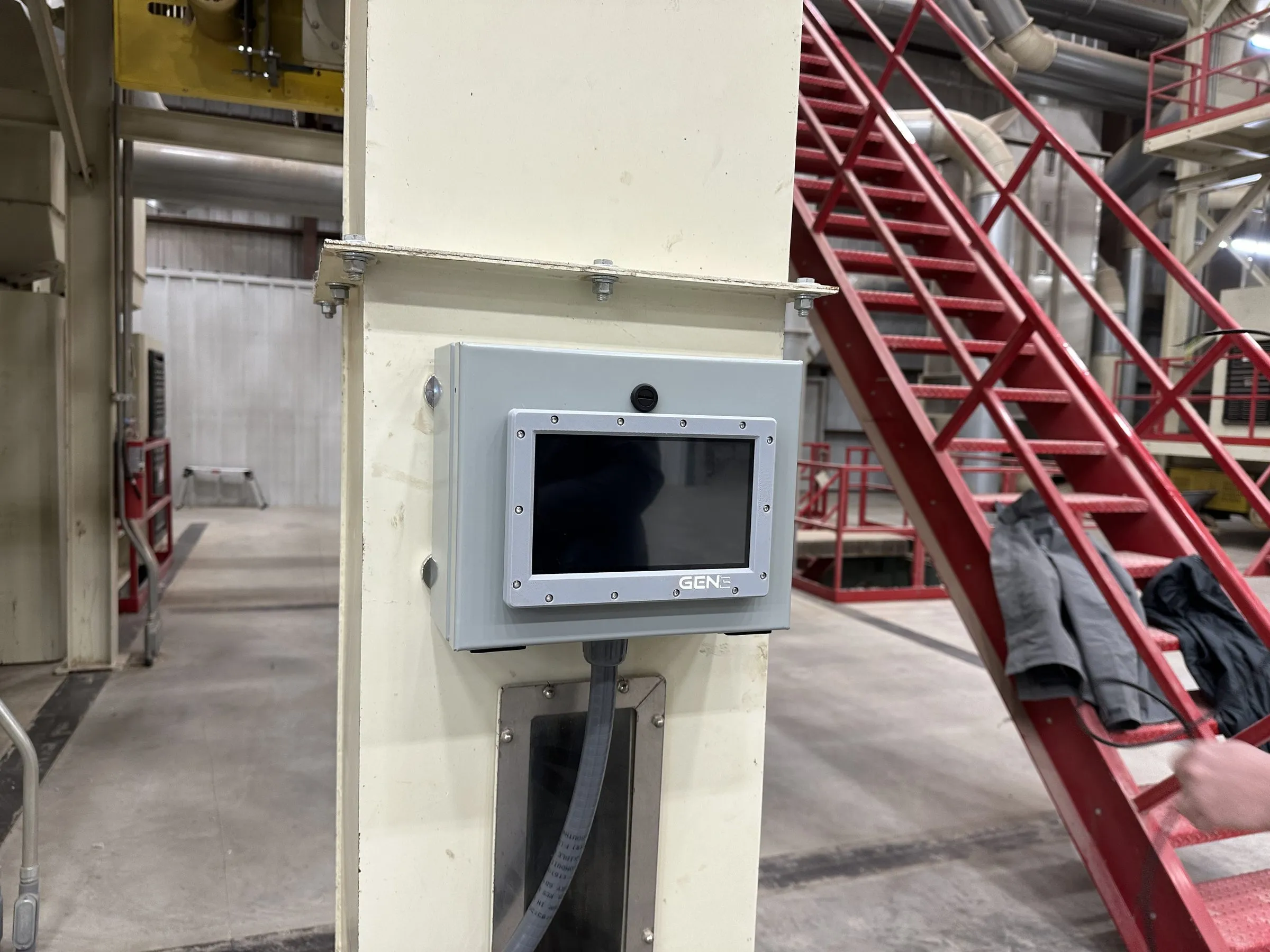 A sealed Gen 3 Dynamics panel-mount touchscreen bolted to a column in a working gin