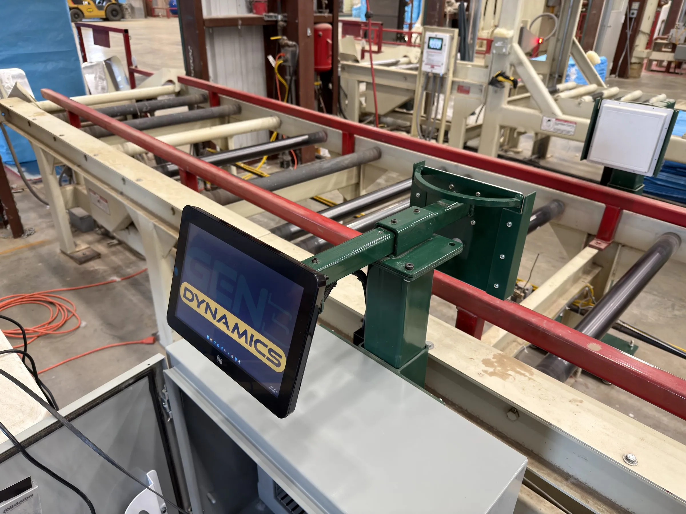 An MS-1 sensor head and touchscreen mounted over the roller conveyor of a bale line